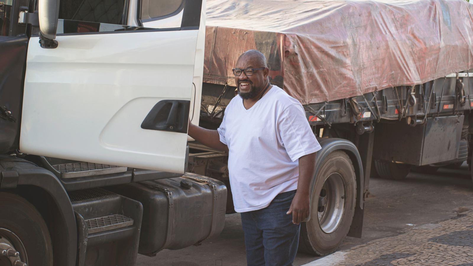 Transporter beside a loaded cargo truck